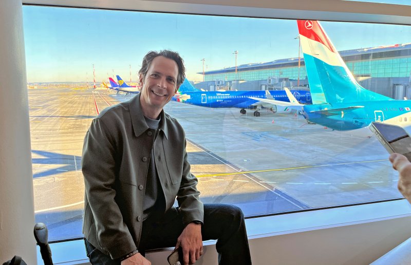 Jo Hiller am Flughafen, im Hintergrund stehen mehrere Flugzeuge.