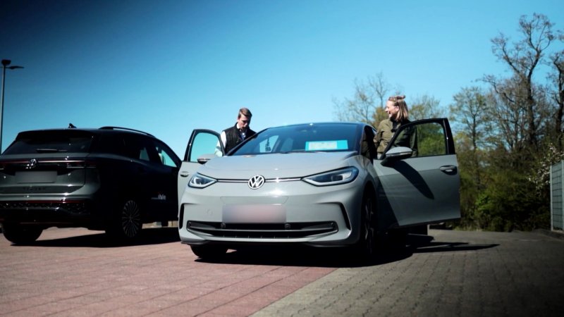 Ein Mann und eine Frau steigen in ein E-Auto.